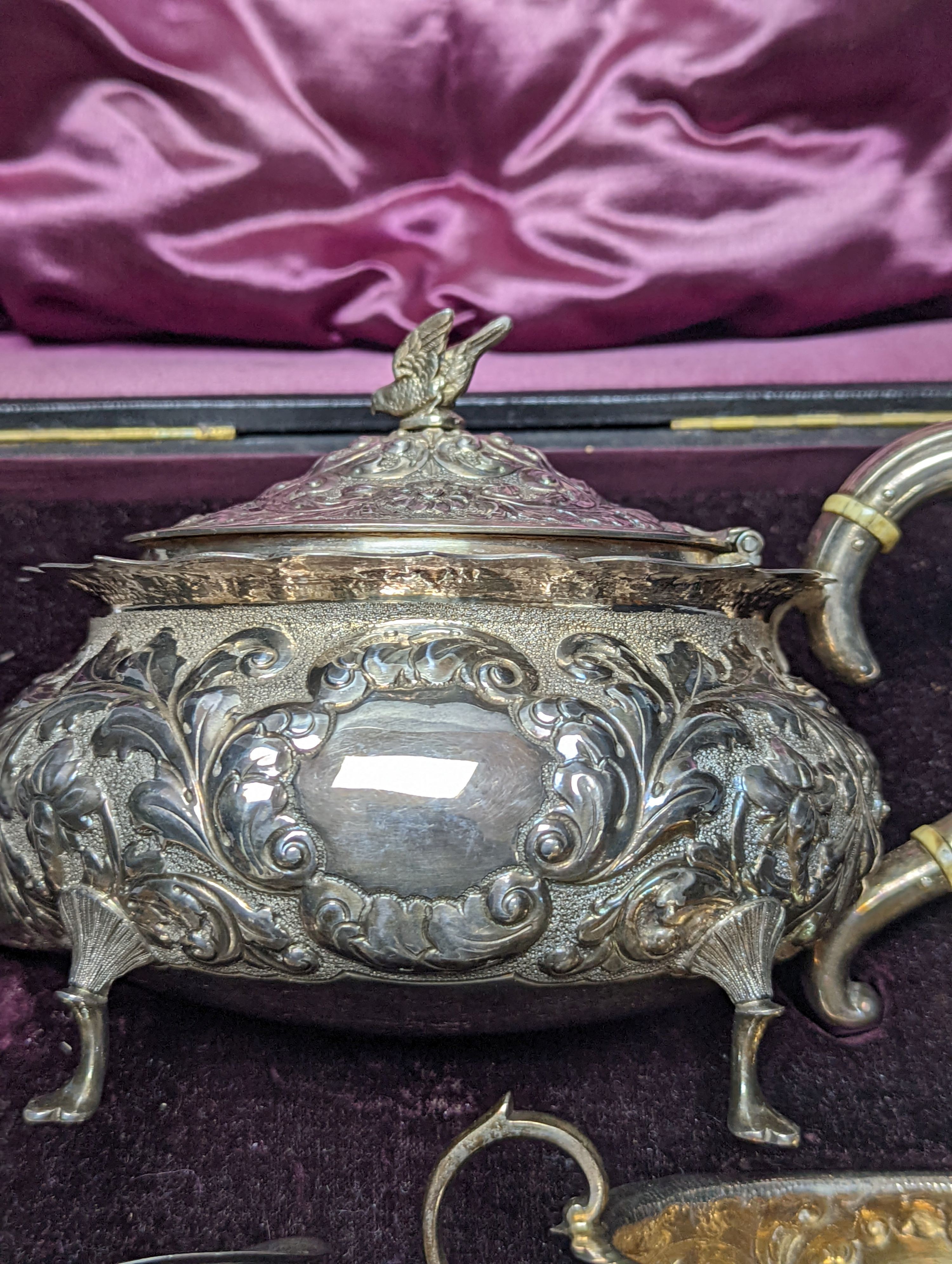 A cased late Victorian Scottish repousse silver three piece tea set, Hamilton & Inches, Edinburgh, 1897, gross 21.5oz.